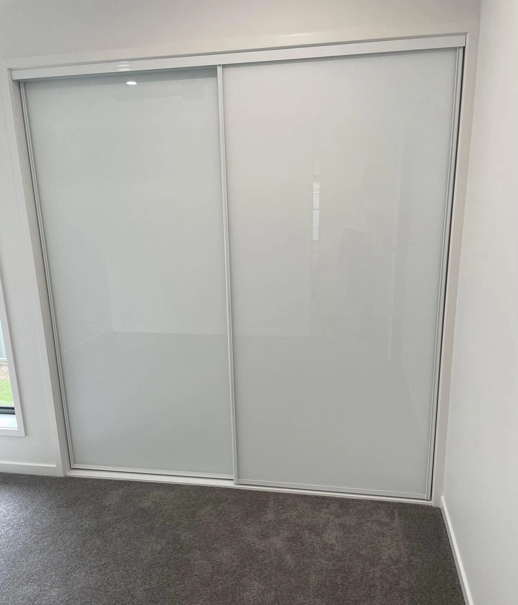 White glass sliding wardrobe doors in a bedroom — gallery wardrobe glass white