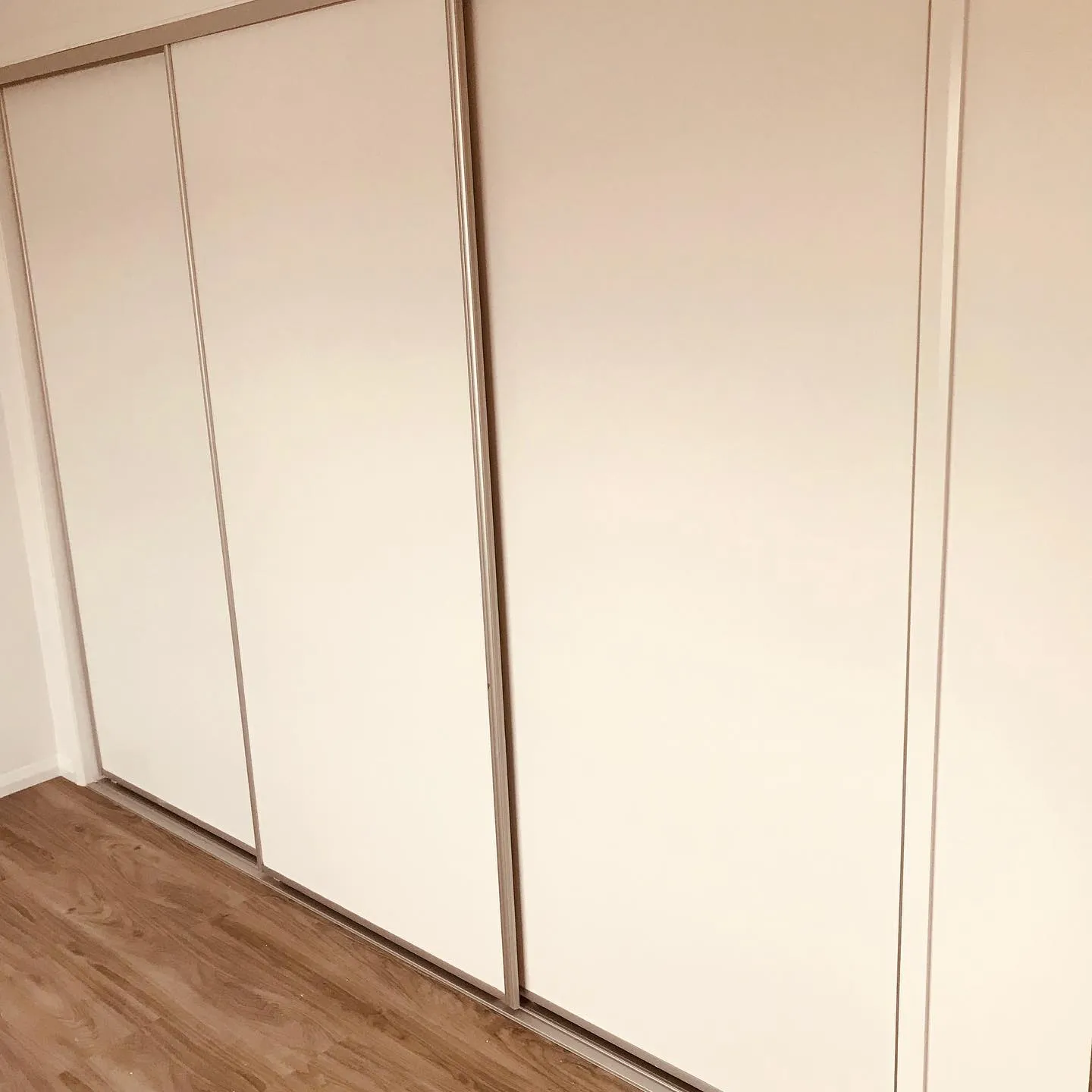 Cream vinyl sliding wardrobe doors — gallery wardrobe vinyl cream