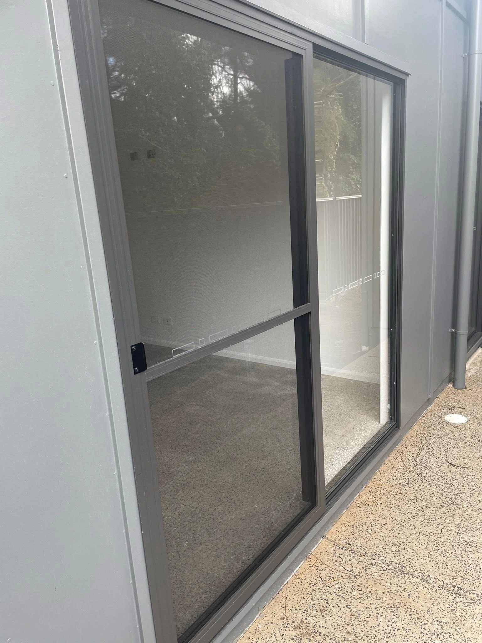Sliding security screen door beside a patio — gallery security sliding door